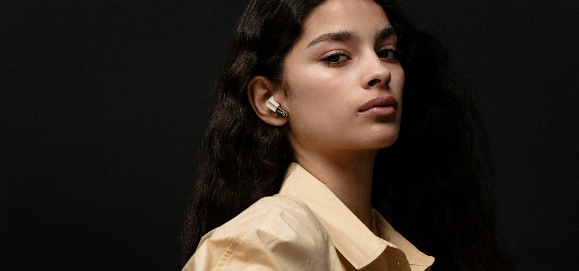 Sudio E3 Black TWS earbuds on a male model