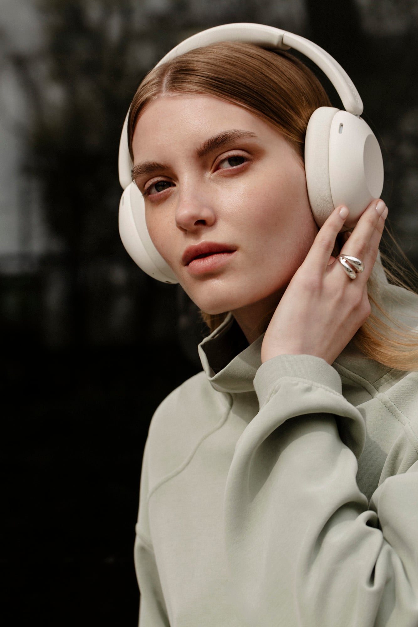 Sudio K3 Pro milky white headphones on a model